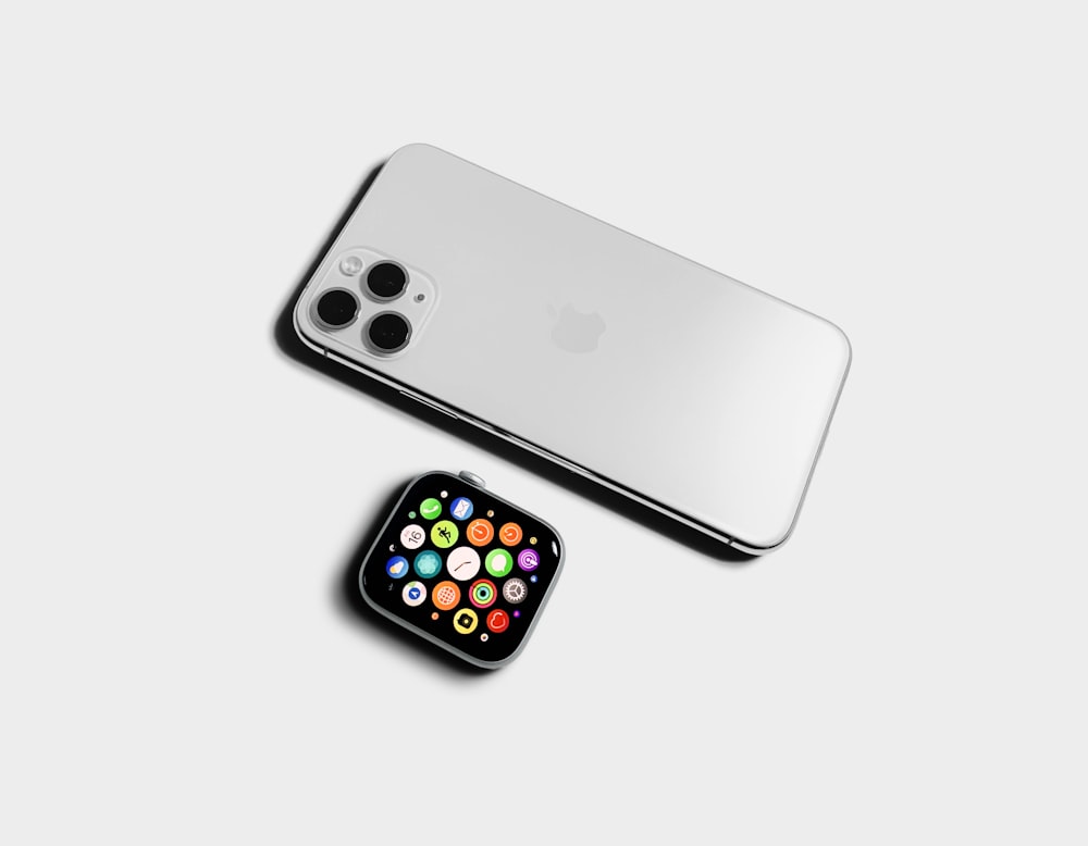 silver iphone 6 beside black and yellow iphone case