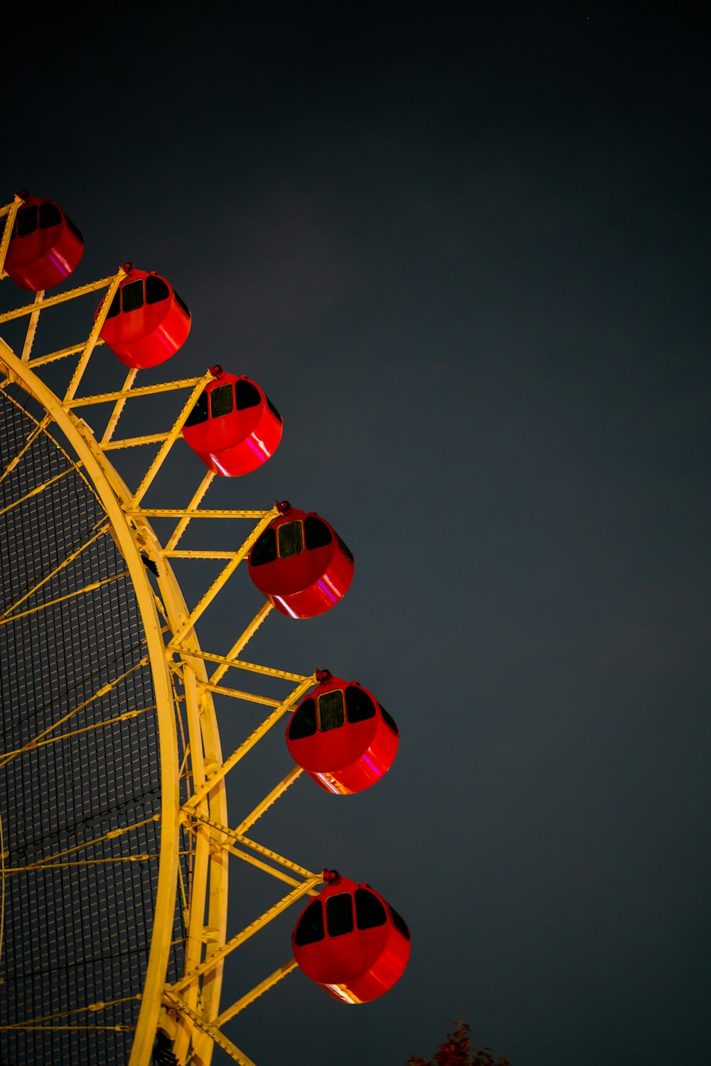 red and white ferris wheel under blue sky during daytime