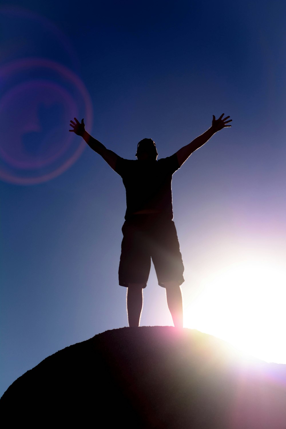 man in black shirt raising his hands