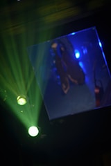 A matchmove scene showing tracking points glowing softly in gold on a dark background.