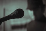 A close-up of a microphone in a dimly lit studio.