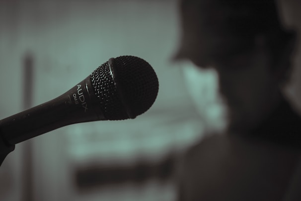 Close-up of a microphone with soft lighting, capturing the intimate vibe of a live gospel broadcast.