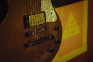 Close-up of a guitar with a raffle ticket and money symbolizing the prize.