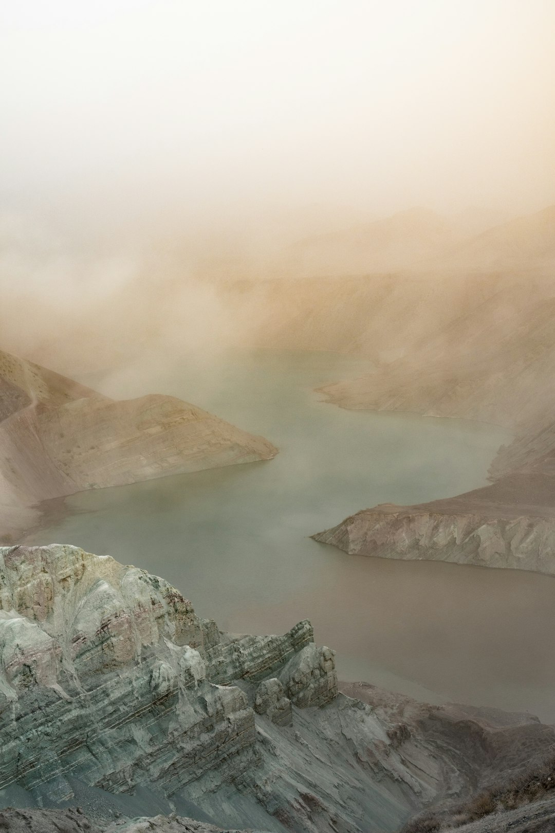 brown and gray mountains near body of water during daytime