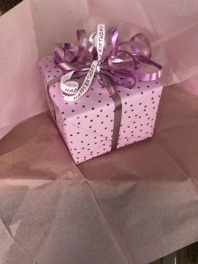 Soft pastel-toned birthday gift box with delicate ribbons and floral accents.
