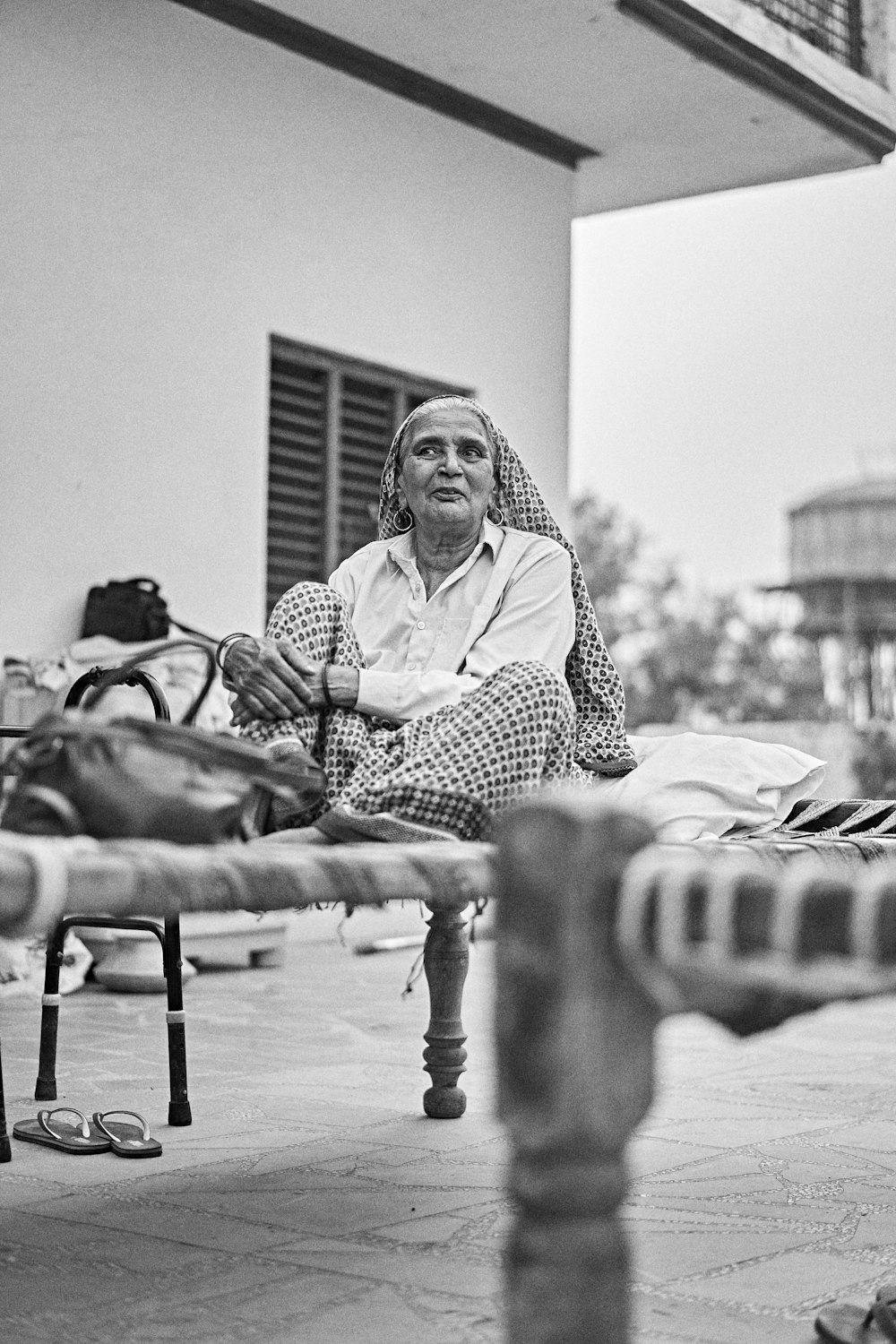 woman in black and white polka dot robe sitting on bench