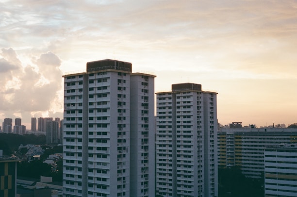 Modern high-rise residential buildings under a clear sky at sunset.