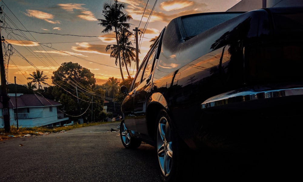 black car on gray asphalt road during sunset