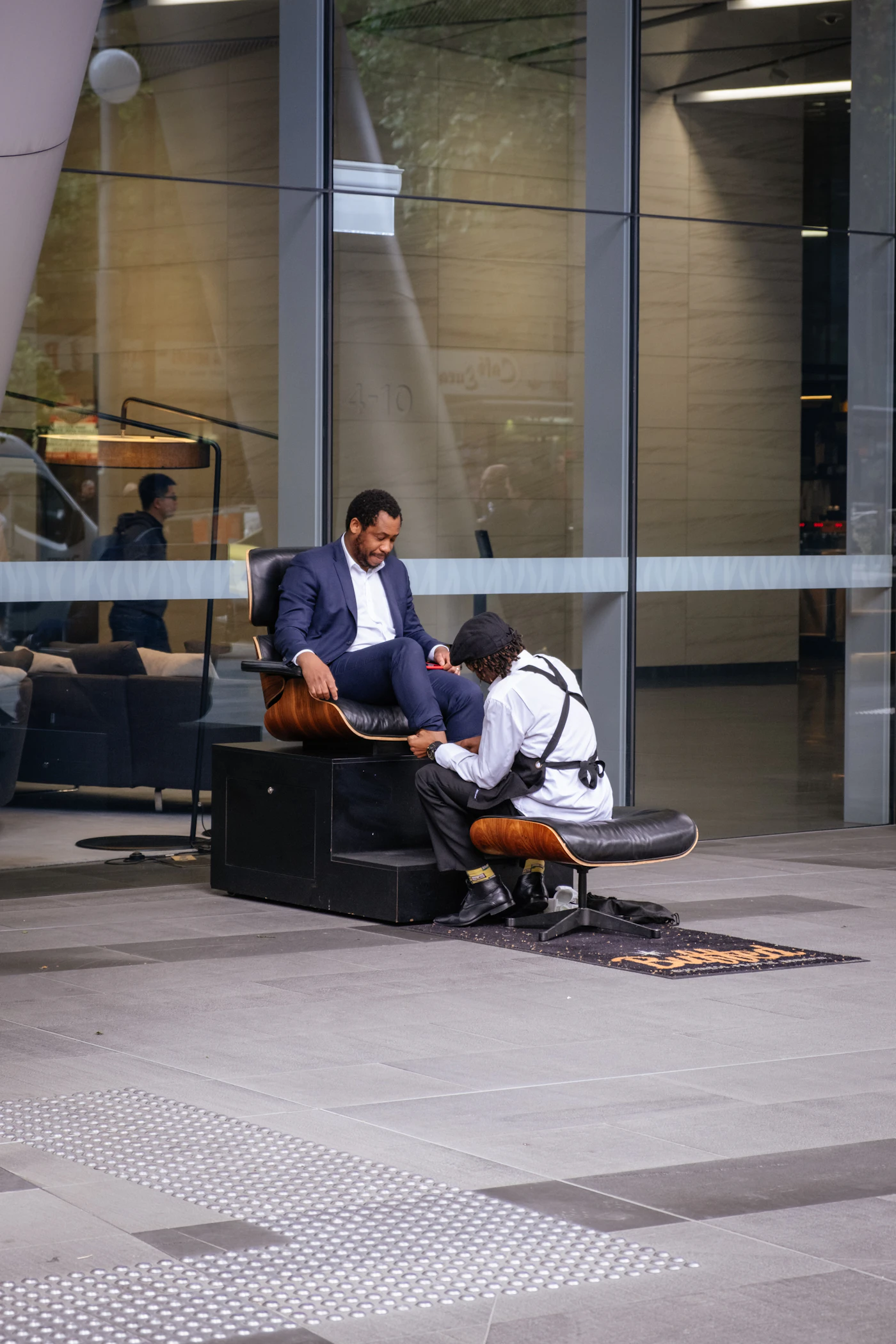 A man in a white dress shirt sitting on a black office chair