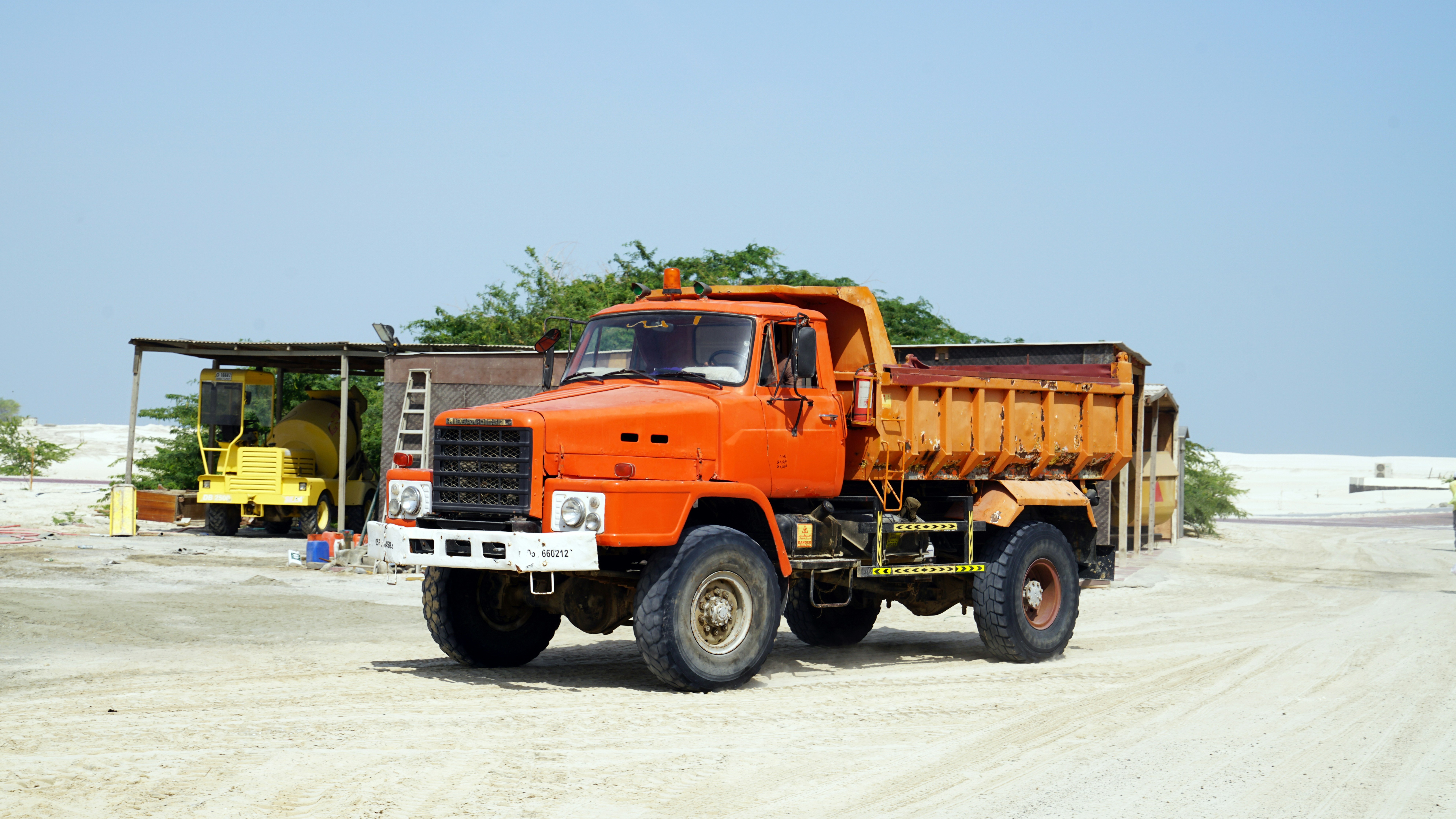 orange and black truck on road during daytime