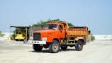 orange and black truck on road during daytime