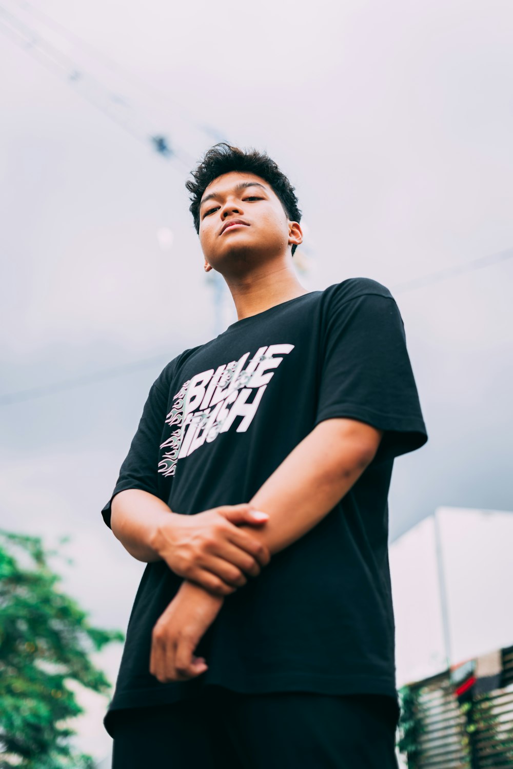 man in black crew neck t-shirt standing during daytime