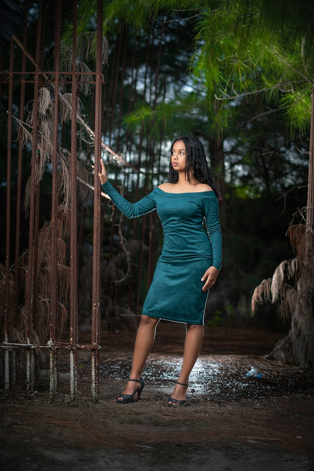 woman in blue long sleeve dress standing on water