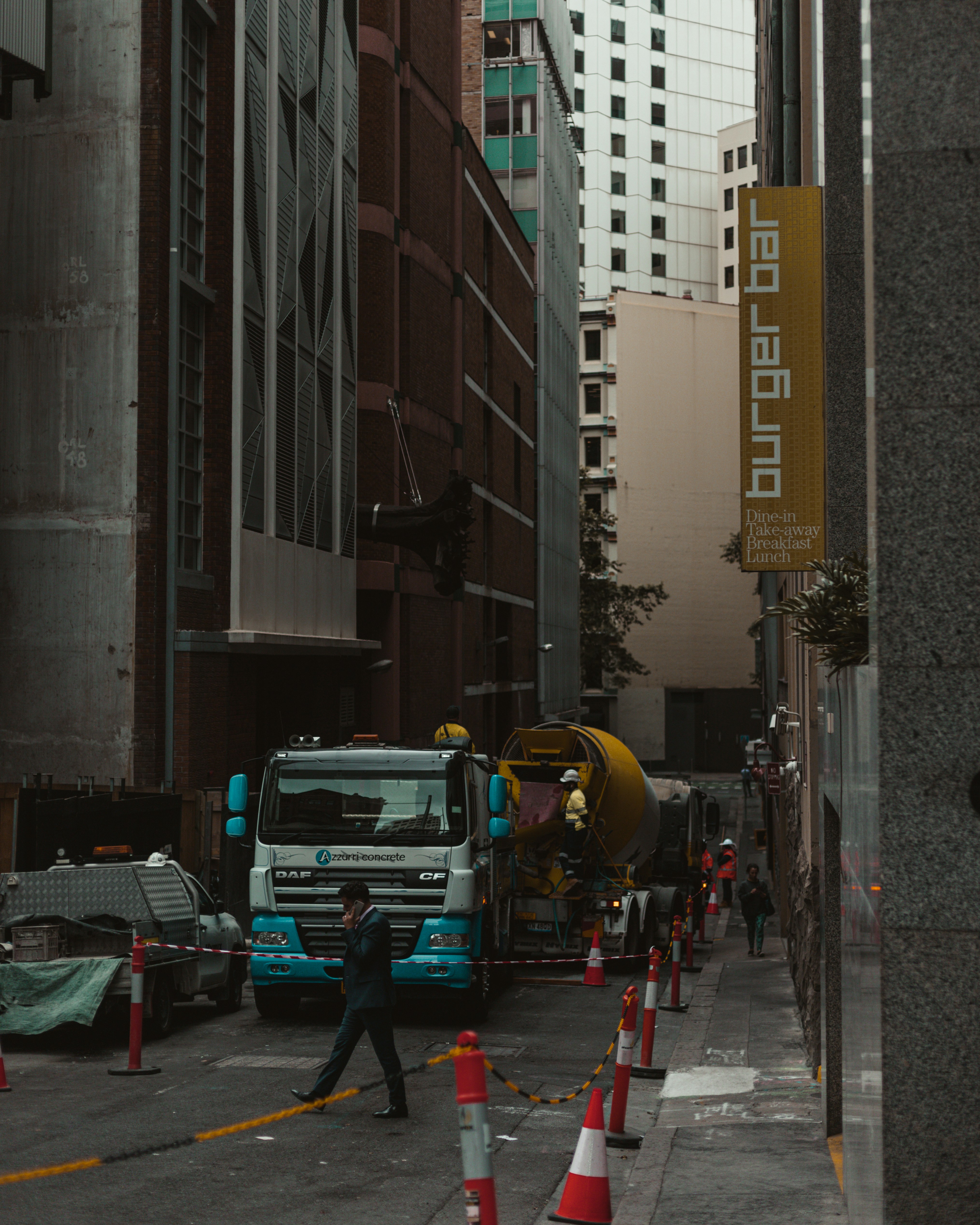 cars parked on side of the road in between buildings