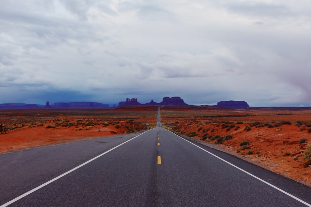 black asphalt road under cloudy sky during daytime