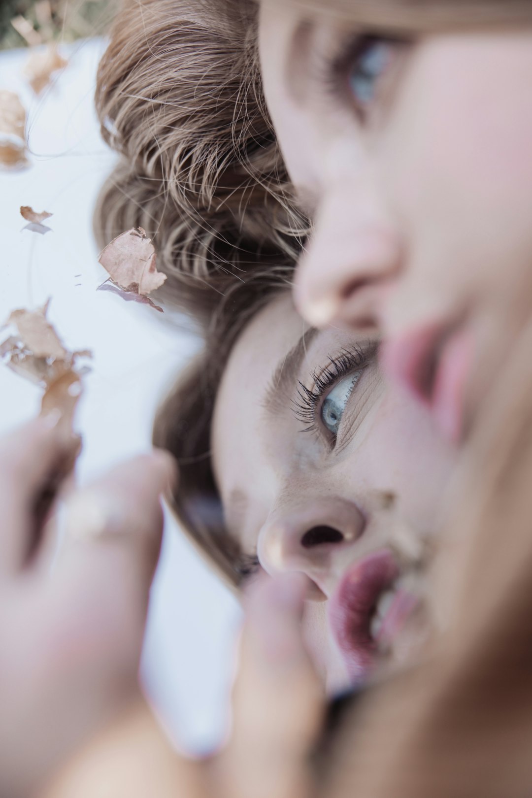 girl with brown hair lying on white bed