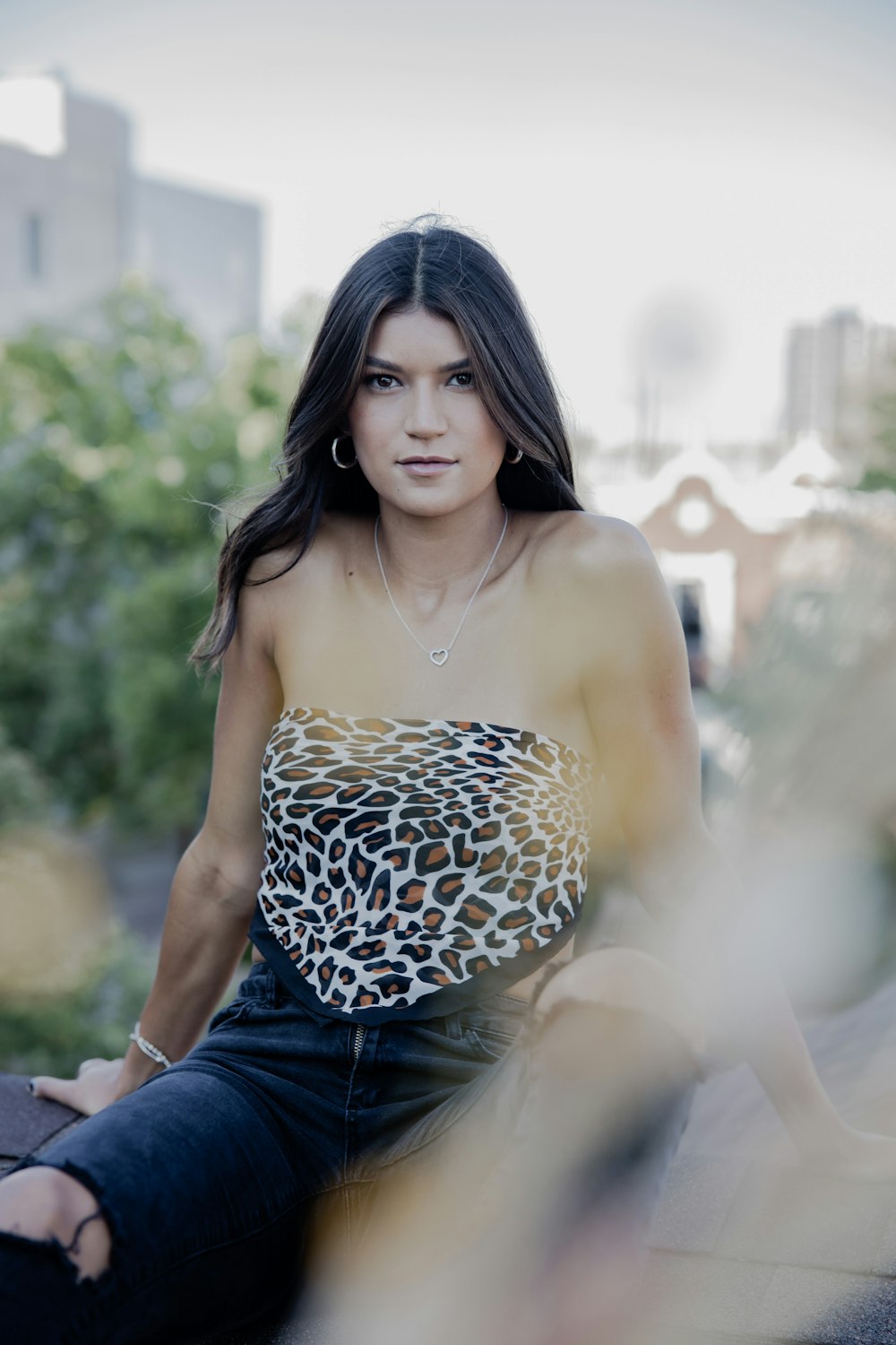 woman in black and white leopard print spaghetti strap top and blue denim shorts