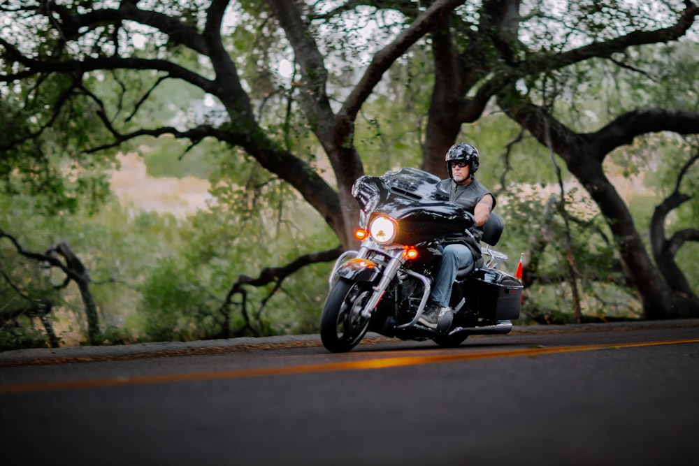 man riding motorcycle on road during daytime