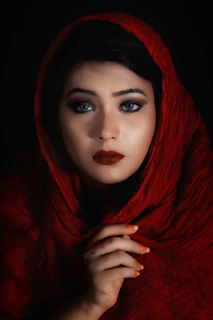 A striking close-up of a model wearing a bold Zaga Africa graphic tee under dramatic red lighting.
