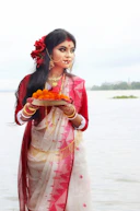 woman in red and white dress holding plate with food