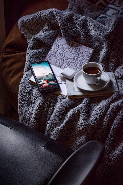 black android smartphone on white ceramic saucer