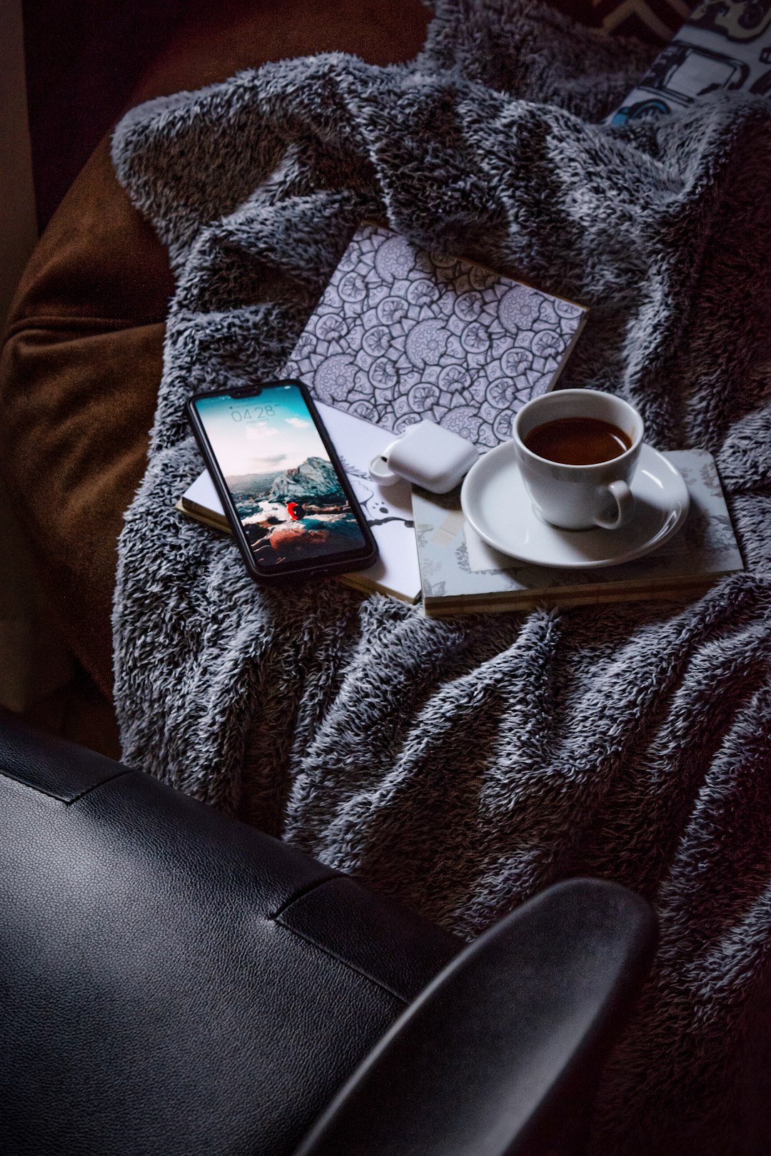 black android smartphone on white ceramic saucer