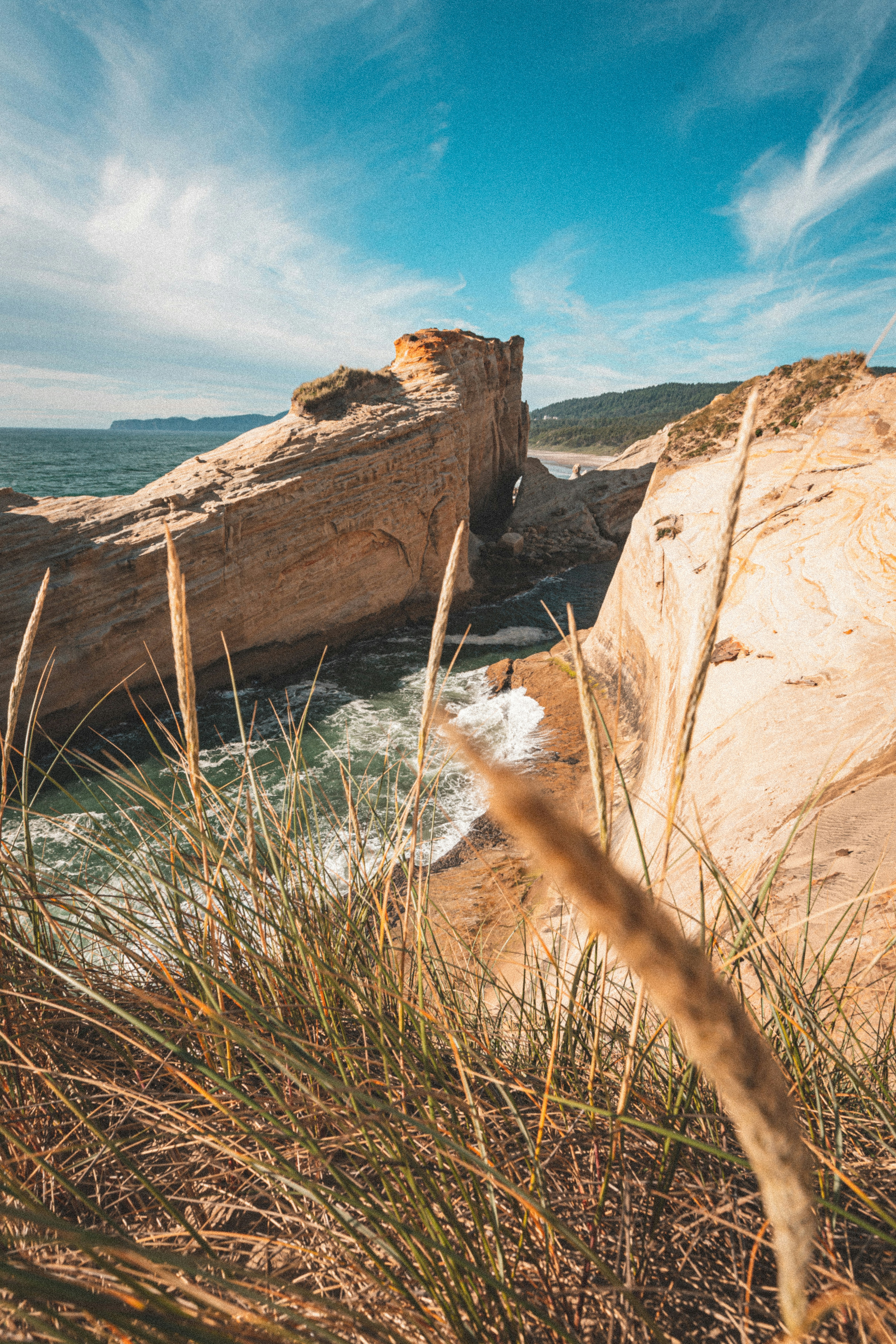 brown rock formation near body of water during daytime