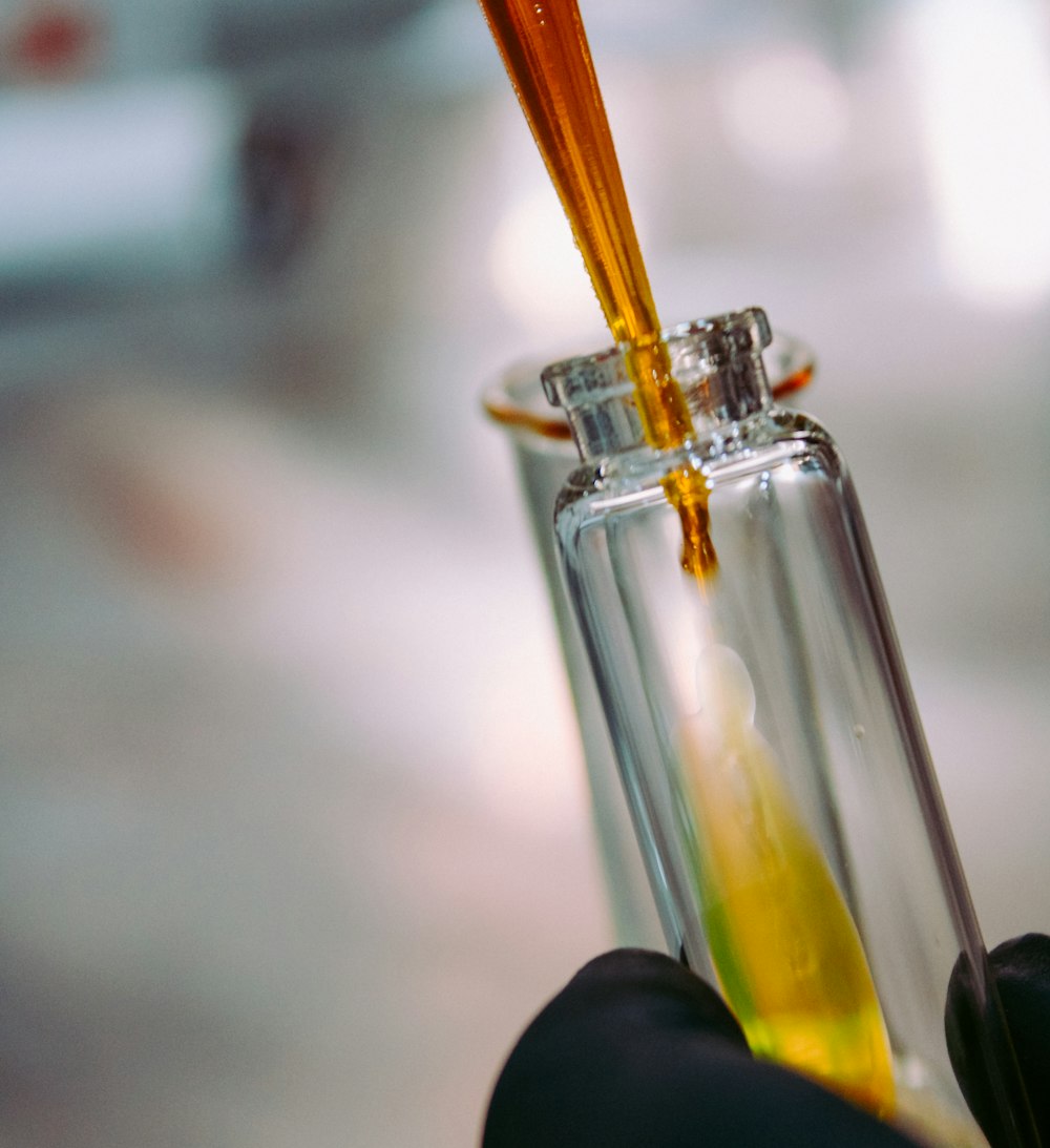 yellow straw in clear glass bottle