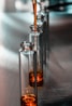 clear glass bottle on white textile