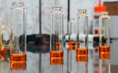 clear glass bottles on black surface