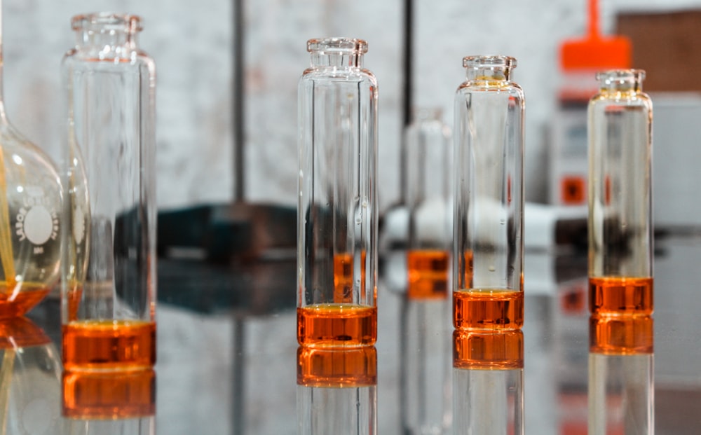 clear glass bottles on black surface