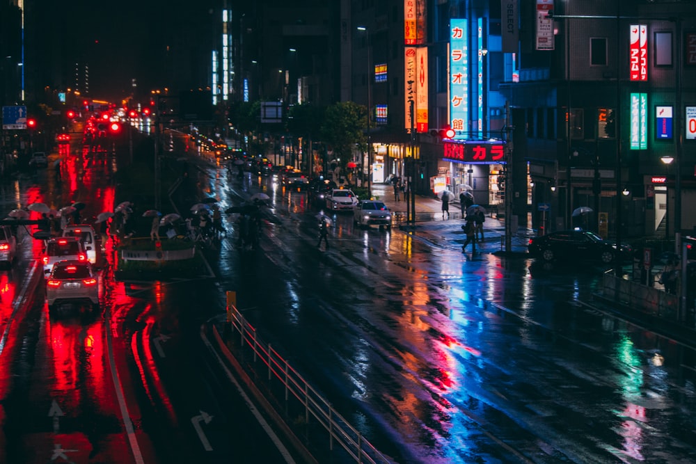 people walking on sidewalk during night time