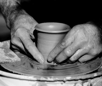 grayscale photo of person holding round plate
