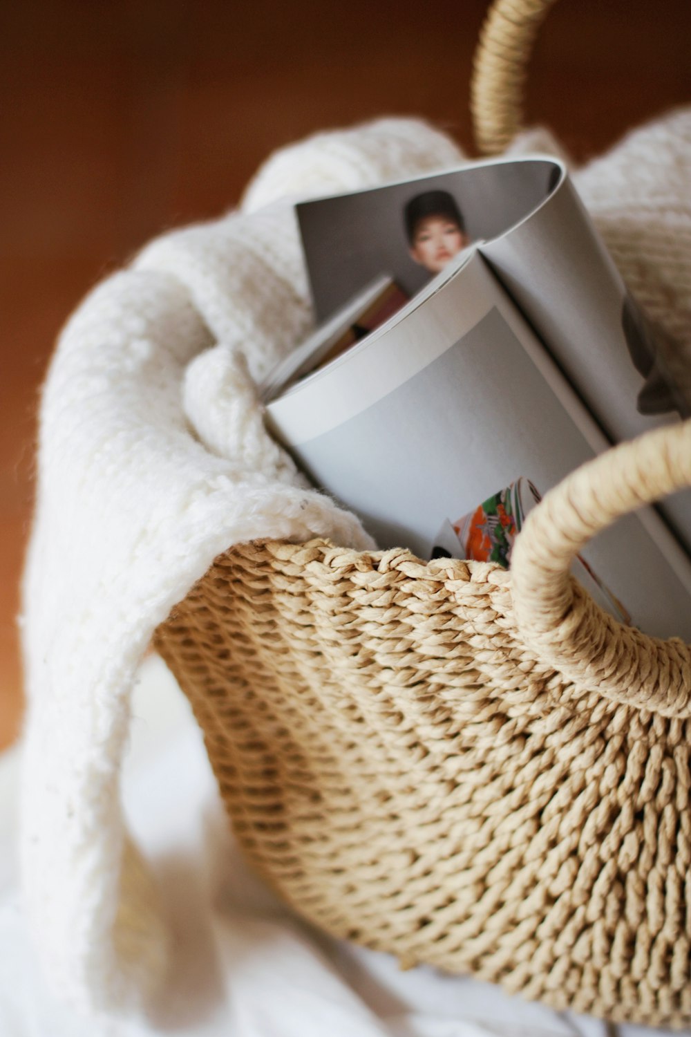 white textile on brown woven basket