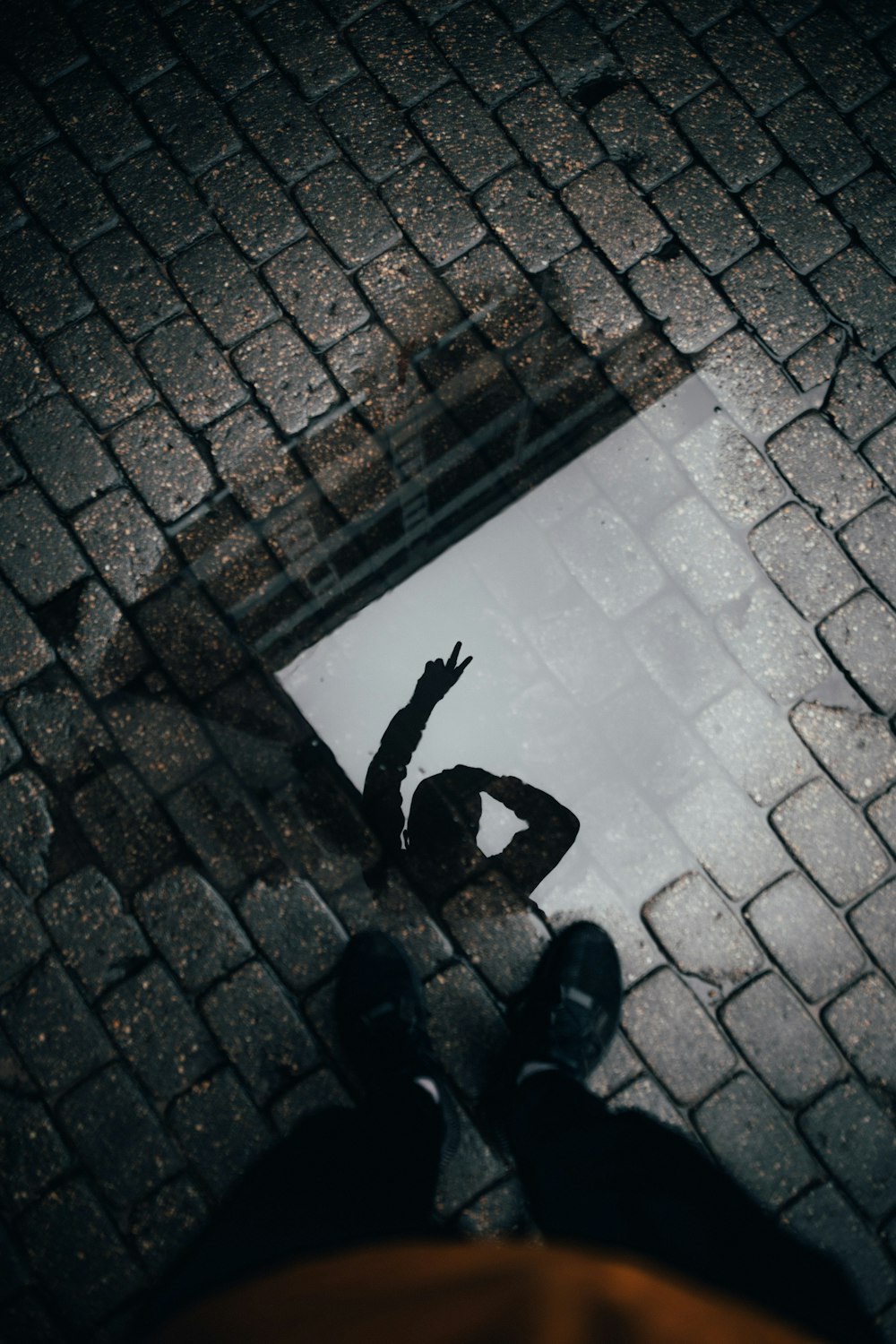 person in black pants standing on gray concrete floor