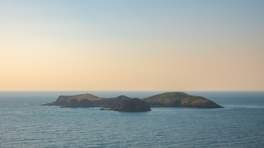 brown and green island on sea during daytime