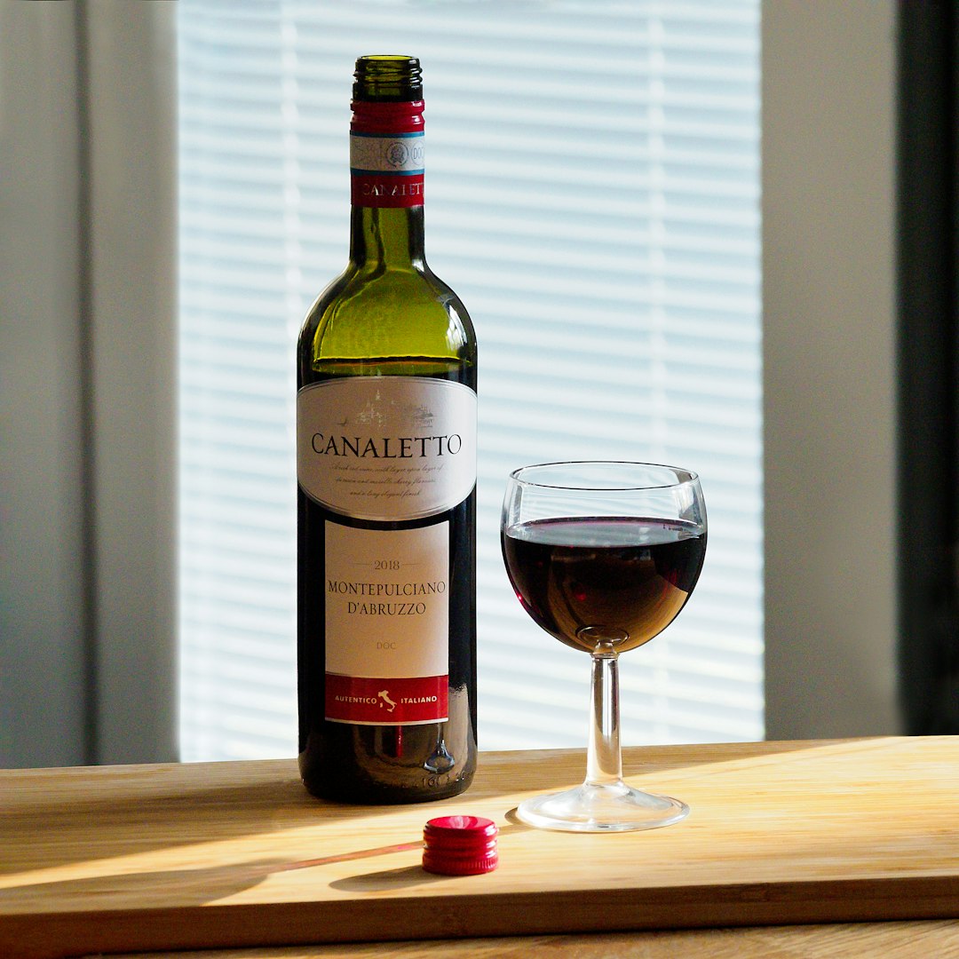 white labeled bottle on brown wooden table