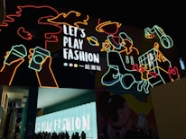 Vibrant neon-lit urban fashion display with layered shadows.