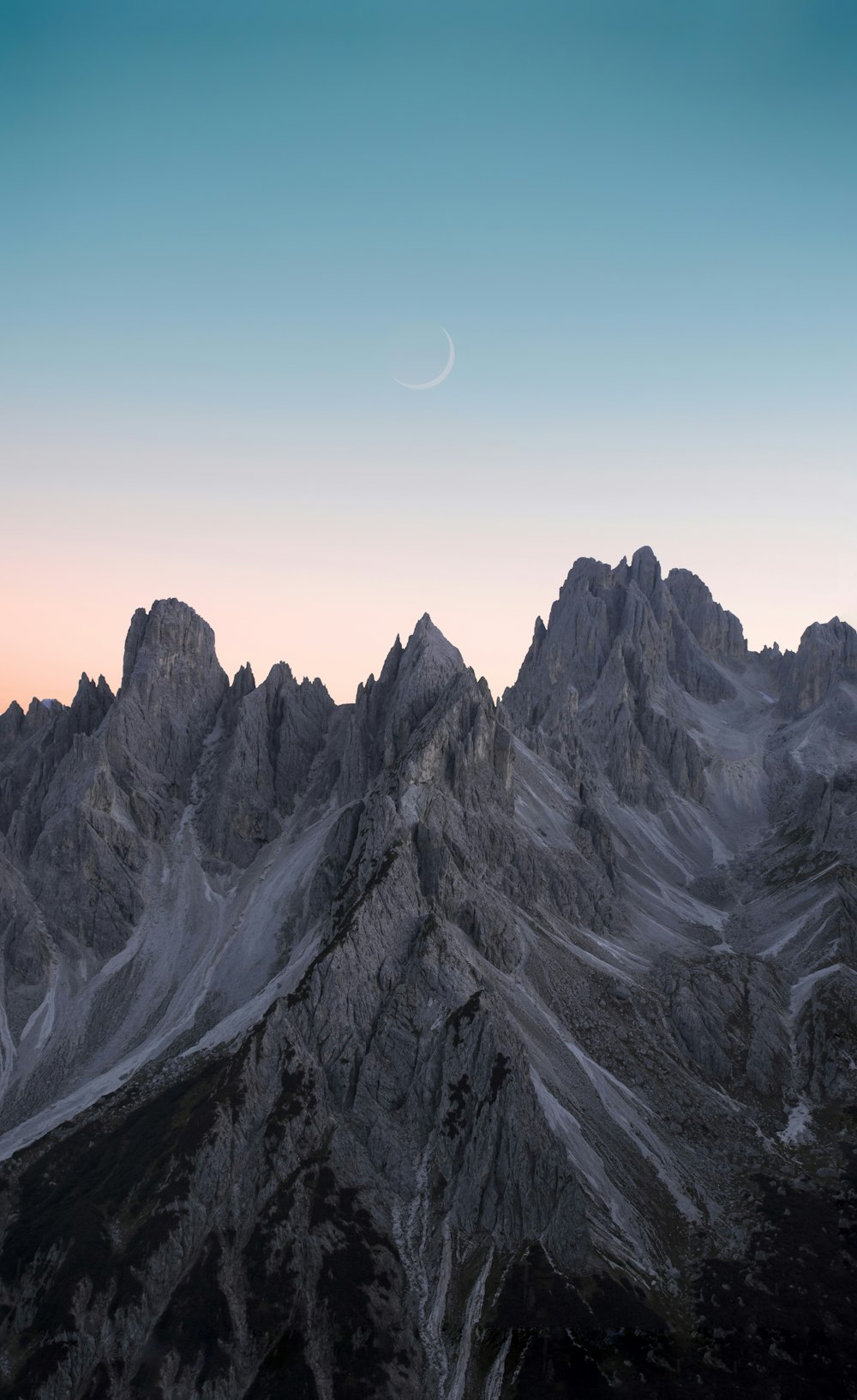 black and white mountains under blue sky