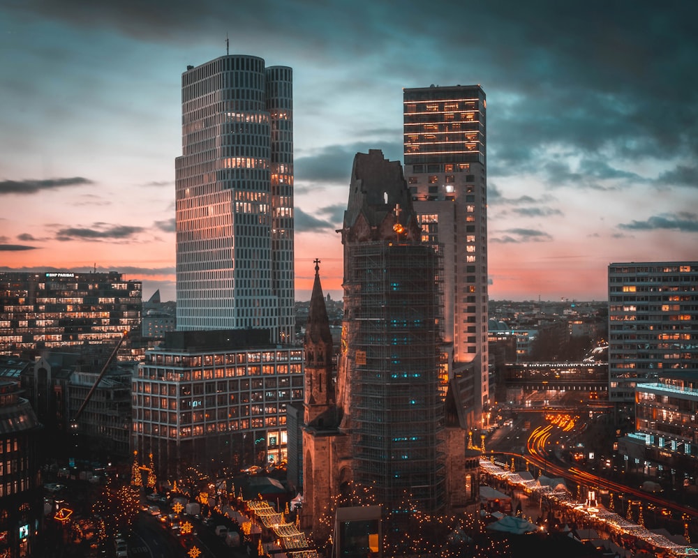 city buildings under blue sky during night time