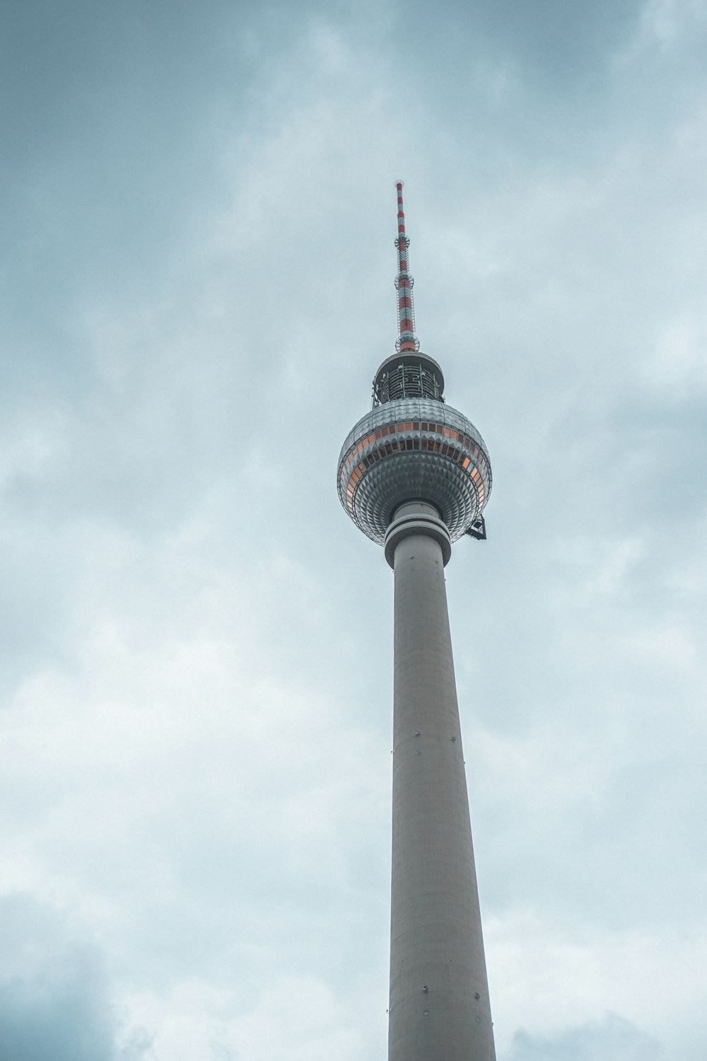 white and black tower under white clouds during daytime