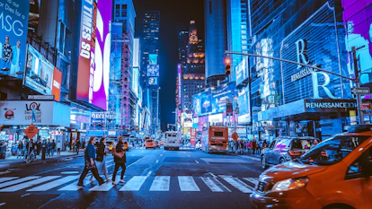 people walking on pedestrian lane during night time
