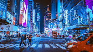 people walking on pedestrian lane during night time