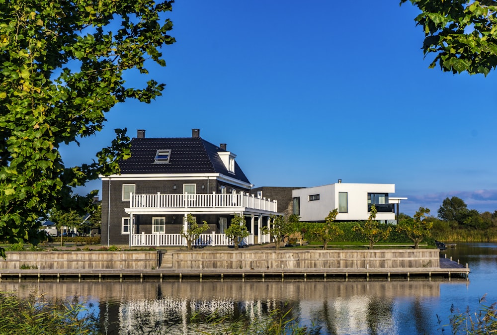 white and black house beside body of water during daytime