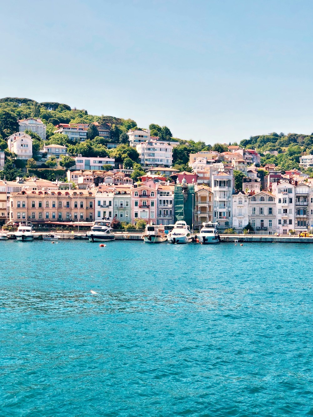 white and brown concrete buildings near body of water during daytime