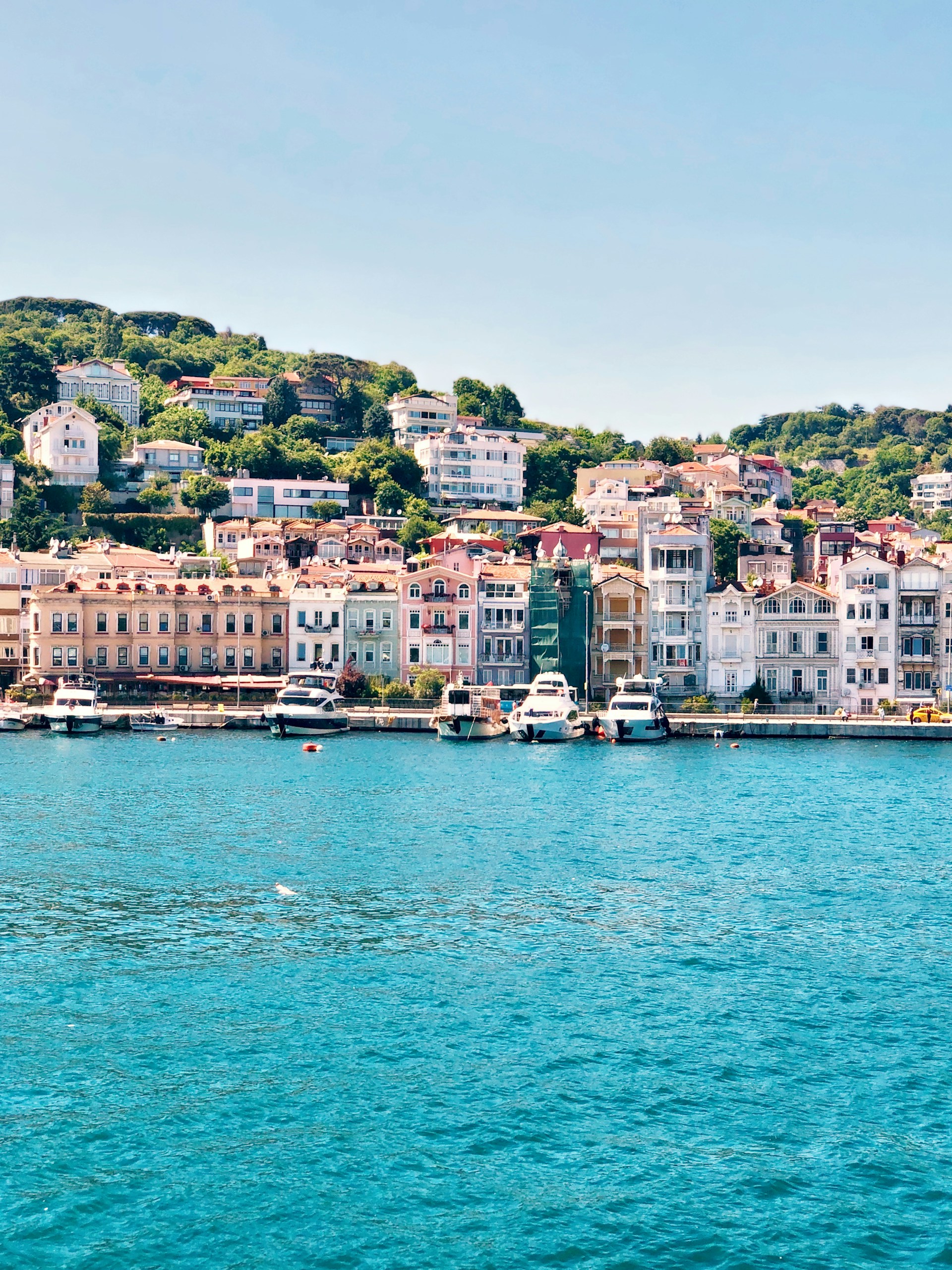 white and brown concrete buildings near body of water during daytime