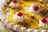 Close-up of a delicious dessert topped with berries and whipped cream.