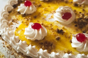 Close-up of a delicious dessert topped with berries and whipped cream.
