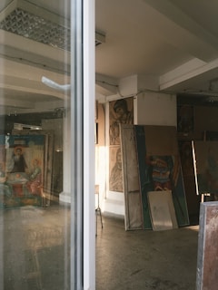 A sunlit museum room with paintings depicting Christian creativity and worship.