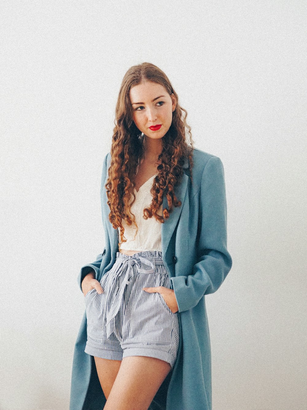 woman in gray blazer and white and black striped dress